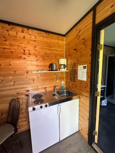 a kitchen with a sink and a counter top at Tommerneset Camping in Innhavet