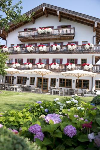 a hotel with flowers in front of it at Das Achental Resort in Grassau