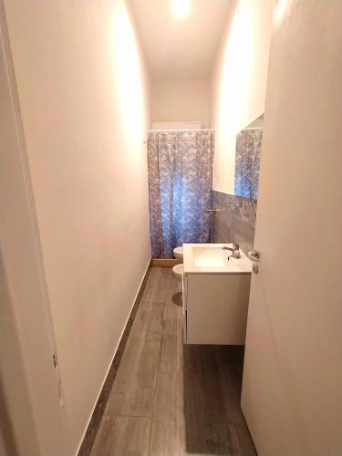 a small bathroom with a sink and a mirror at Casa Cristina Beach in Marina di Ragusa