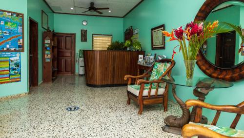 a room with a table with flowers and a mirror at Seagrape Plantation Resort & Dive Center in West End