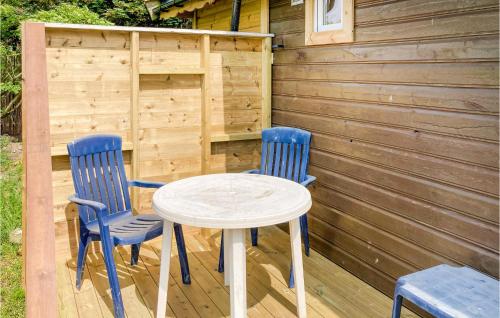 two blue chairs and a table on a wooden deck at Beautiful Home In Kleppe With Wifi in Bore