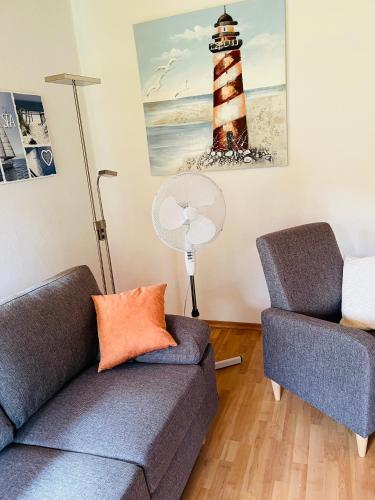 a living room with two couches and a lighthouse at Ferienwohnanlage Sturmhöhe in Welt