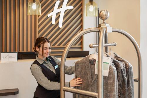 a woman standing next to a mannequin in a store at Holiday Inn Birmingham Airport - NEC by IHG in Bickenhill