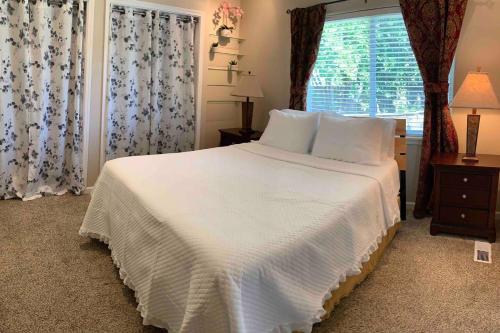 a bedroom with a large white bed and a window at Cozy Guesthouse- Individual Unit Private & Relaxing in Concord