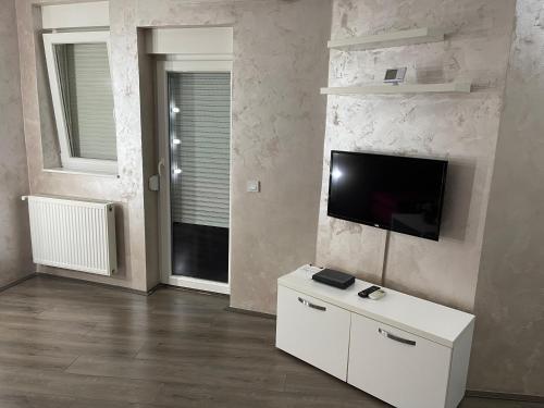 a living room with a flat screen tv on a wall at La Apartamento in Jagodina