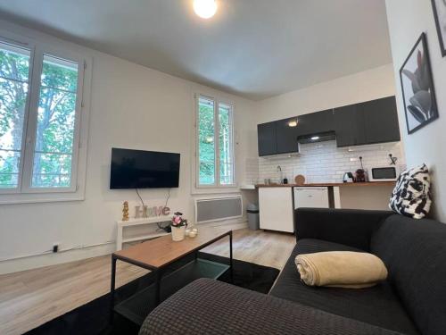 un salon avec un canapé et une table dans l'établissement Le Castelet - Paisible T2 proche métro, à Toulouse