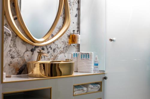a bathroom with a sink and a mirror at Pela Veranda Exquisite Suites in Neos Marmaras