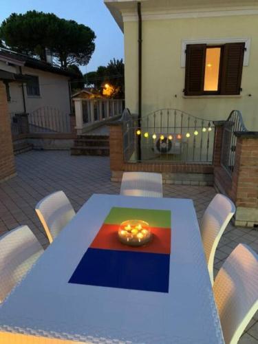a table with a bowl of candles on top of it at Villa Parisi, Fano, Marche, Italian Villa in Fano