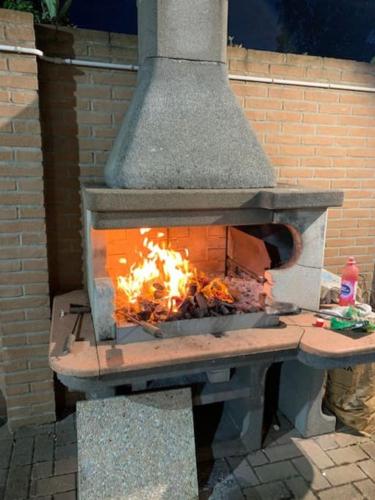 a brick oven with a fire inside of it at Villa Parisi, Fano, Marche, Italian Villa in Fano
