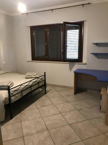 a room with a bed and a bench and a window at Villa Parisi, Fano, Marche, Italian Villa in Fano