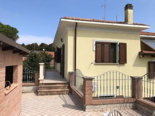 a house with a gate and a staircase in front of it at Villa Parisi, Fano, Marche, Italian Villa in Fano