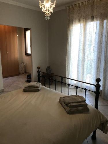 a bedroom with a large bed with two towels on it at Villa Parisi, Fano, Marche, Italian Villa in Fano