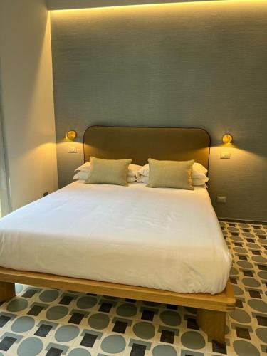 a large white bed with two pillows on it at Affittacamere Dai Baracca in Riomaggiore