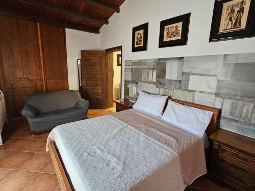 a bedroom with a bed and a chair at Gulliver's Nest in Castellammare del Golfo
