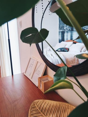 a bedroom with a bed and a table with a plant at Apartment Volosko View in Opatija