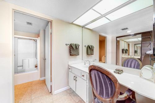 a bathroom with a sink and a mirror at Mesquite Chic Retreat Permit# 3160 in Palm Springs