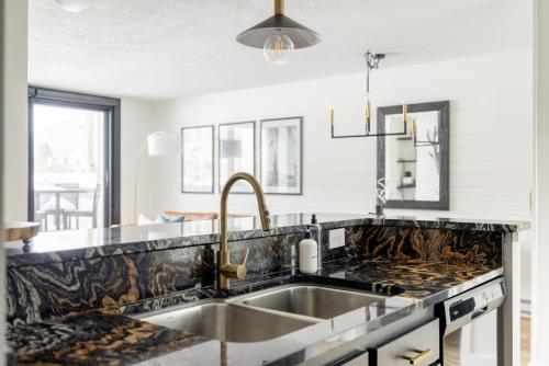 a kitchen with a sink and a counter top at Lakeside & MTN View Condo - Pool-Hot Tub-Gym-Sauna in Dillon