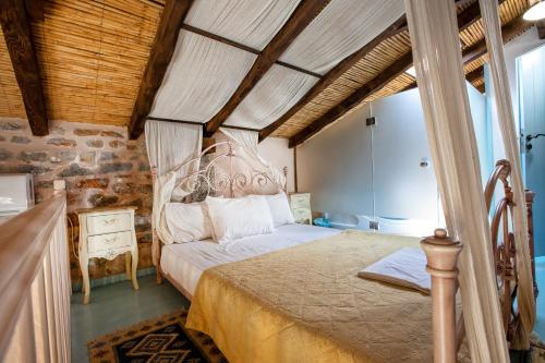 a bedroom with a bed in a room with wooden ceilings at Ktima Karageorgou in Areopolis