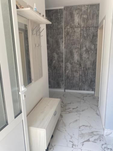 a bathroom with a shower with a bench in it at Apartman Lara in Sveti Stefan