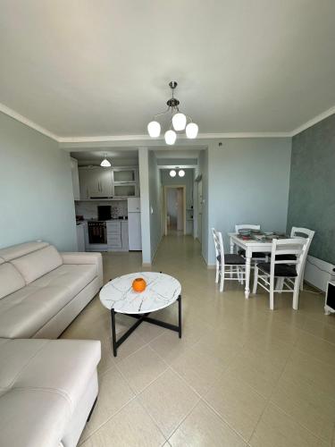 a living room with a couch and a table at Apartment for rent Piqeras, Sarande in Piqeras