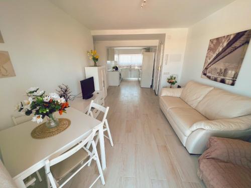 a living room with a couch and a table at Mi Sueño by Residea in Torremolinos