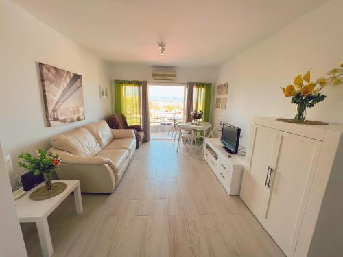 a living room with a couch and a tv at Mi Sueño by Residea in Torremolinos