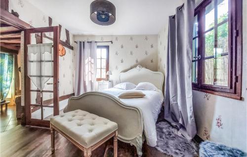 a bedroom with a bed and a chair and windows at Pet Friendly Home In Touffreville With Kitchen in Touffreville