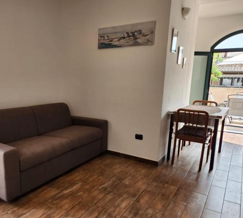 a living room with a couch and a table at Domus Mariposa in Tortolì