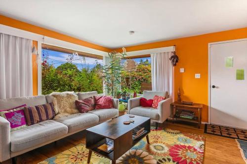 a living room with a couch and a table at Boho Bliss Bungalow in Shoreline