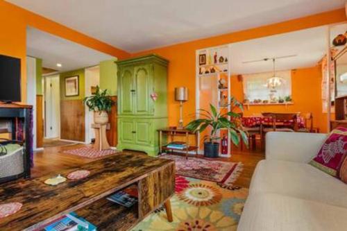 a living room with a couch and a table at Boho Bliss Bungalow in Shoreline