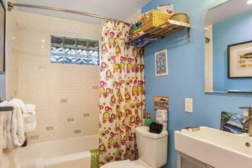 a bathroom with a shower and a toilet and a sink at Boho Bliss Bungalow in Shoreline