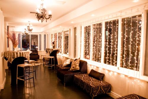 a living room with christmas lights on the windows at Grand Daddy Boutique Hotel in Cape Town