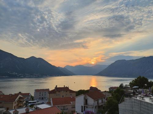 a view of a city and a lake at sunset at Pearl Shell Apartments in Kotor