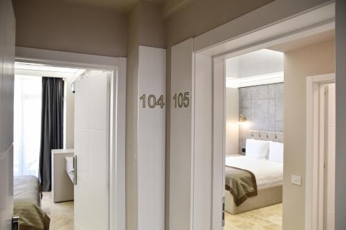 a room with a bedroom with a bed and a door at AXO Boutique HOTEL by BUILDING STEFAN in Mamaia Sat/Năvodari