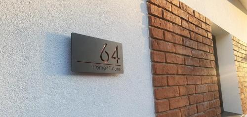 a sign on a wall next to a brick wall at The Luxe Flat No 4, Mansfield, in Mansfield