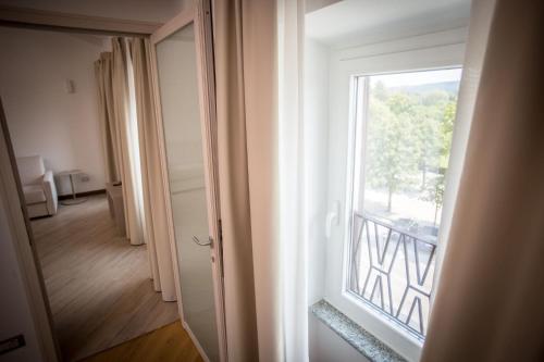 a view of a room with a window at Hotel Ponti in Angera