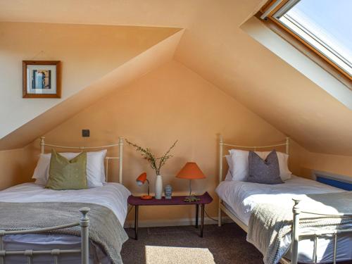 two beds in a room with a roof at Castle View in Scarborough