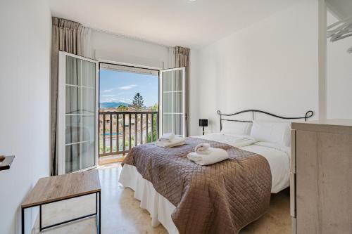 a bedroom with a bed and a large window at 11 Modern apt with sea views, two poolareas, close to parks & beaches Manilva in Manilva