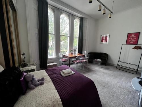 ロンドンにあるHyde Park Studio Has Private Balcony With Tranquil Garden Viewのベッドルーム1室(テディベア付きのベッド1台付)