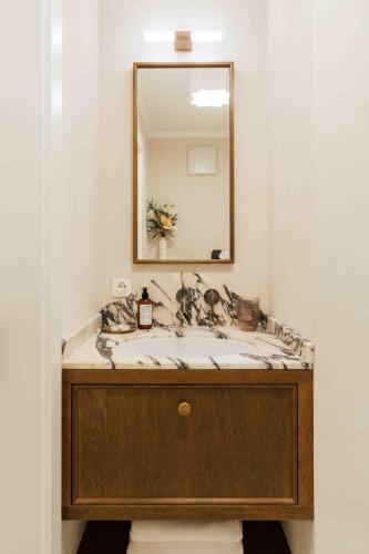 a bathroom with a sink and a mirror at Clemonte Hotel - Your Reception-less Boutique Hideaway in Salzburg