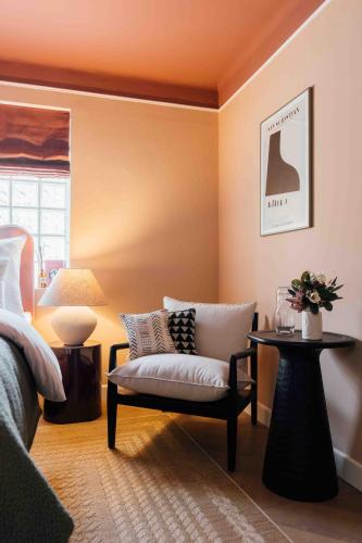 a living room with a couch and a chair at Clemonte Hotel - Your Reception-less Boutique Hideaway in Salzburg