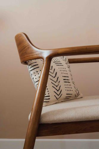 a wooden chair with a pillow on it at Clemonte Hotel - Your Reception-less Boutique Hideaway in Salzburg