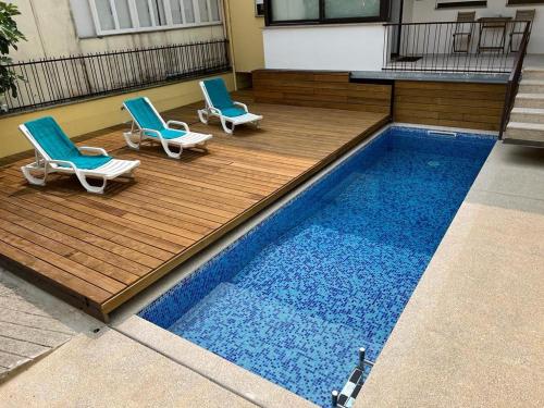 two chairs and a swimming pool on a building at Casa da Vila in Arouca