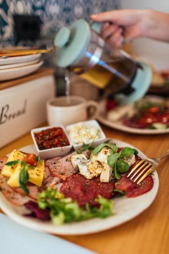 a plate of food sitting on a table with food at Armadillo Houses in Kopaonik