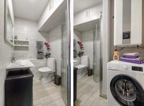 a bathroom with a sink and a washing machine at Riia maantee Apartement in Pärnu