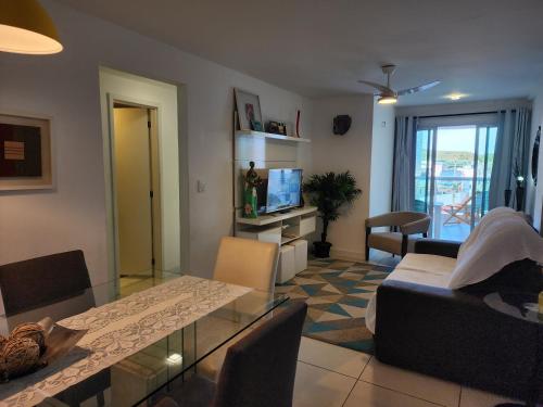 a living room with a table and a couch at PACIFIC - PRAIA DO FORTE in Cabo Frio
