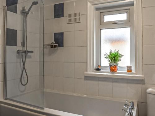 a shower in a bathroom with a window at Castle View in Scarborough