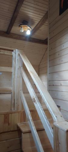 a wooden ladder in a room in a sauna at Крайня Хата in Synevyrsʼka Polyana