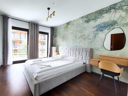 a bedroom with a large bed and a mirror at Turnau City Aparthotel in Krakow