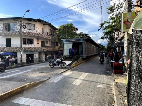 a group of people on motorcycles on a street with a train at apartamento grande, hermoso, acogedor y privado in Medellín